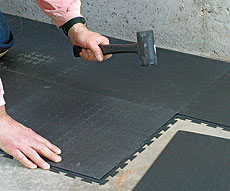 Installation of interlocking rubber tiles; photo courtesy of Best Garage Floor Tiles